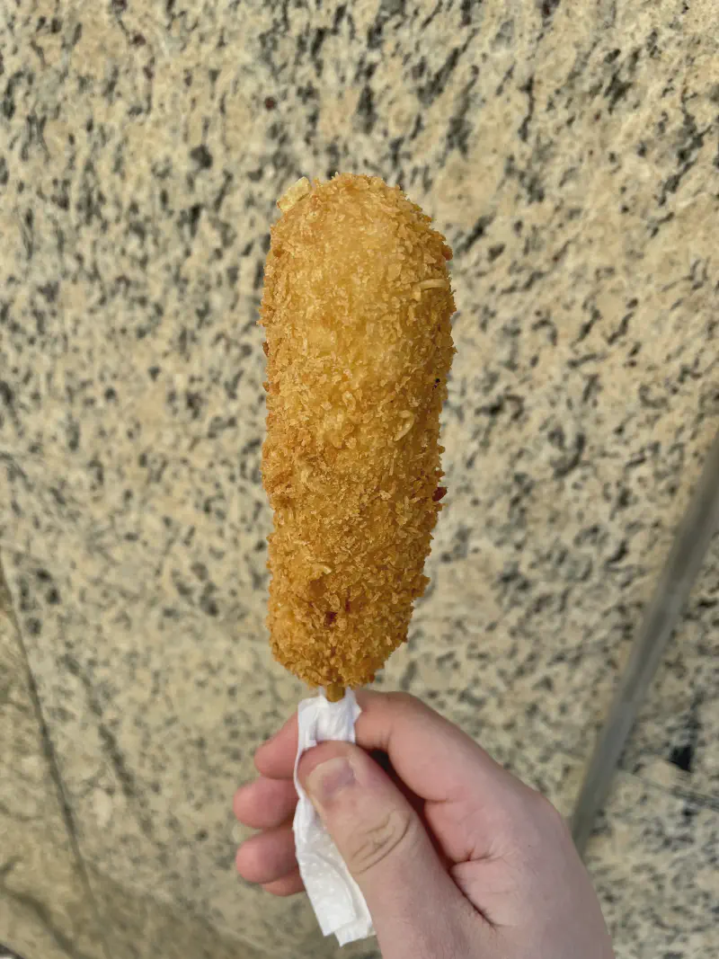 
A corn dog that is half cheese and half sausage.
